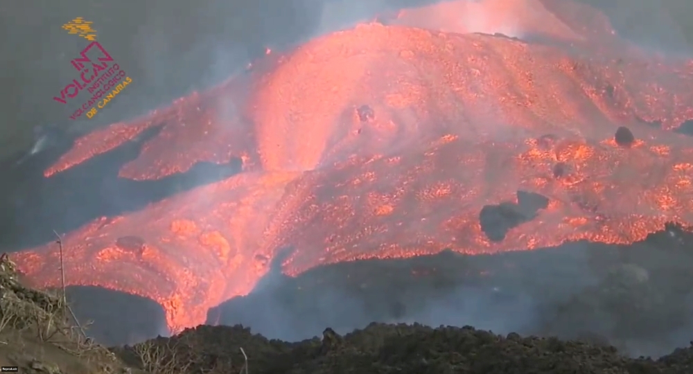 Lava flows as the Cumbre Vieja volcano continues to erupt on the Canary Island of La Palma, Spain October 14, 2021 in this still image taken from a social media video. @INVOLCAN/ via REUTERS