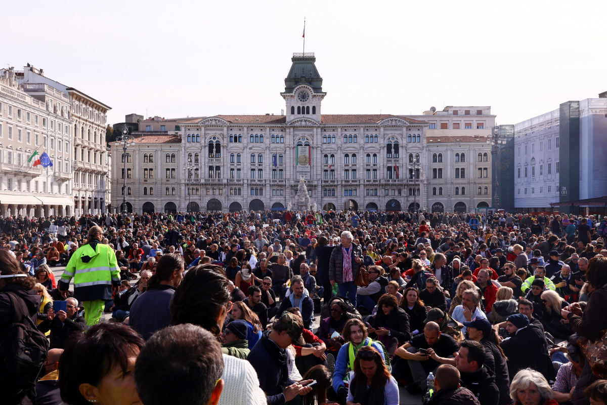 People demonstrate at the Unity of Italy Square (Piazza Unita d'Italia), as Italian riot police try to disperse the protest which has taken place for several days against the implementation of the coronavirus disease (COVID-19) health pass, the Green Pass