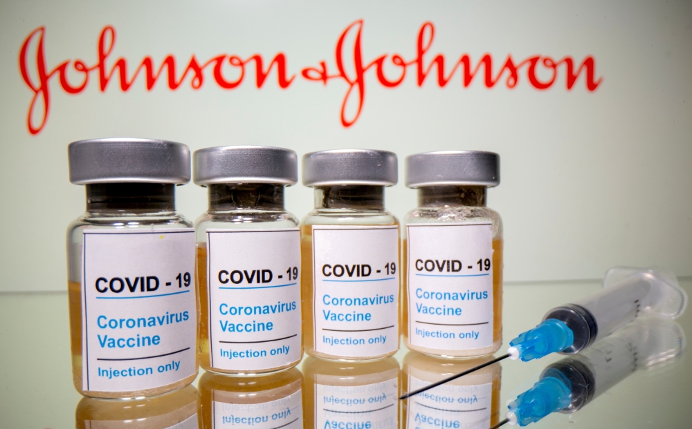 Johnson & Johnson on Tuesday raised its annual adjusted profit forecast, but stuck to its COVID-19 vaccine sales target of $2.5 billion as it works its way through production challenges that have resulted in delays.