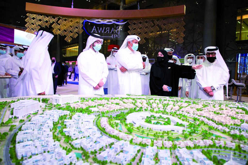Former Prime Minister H E Sheikh Hamad bin Jassim bin Jaber Al Thani (centre), with other officials during a tour of Barwa’s pavilion during Cityscape Qatar 2021. 