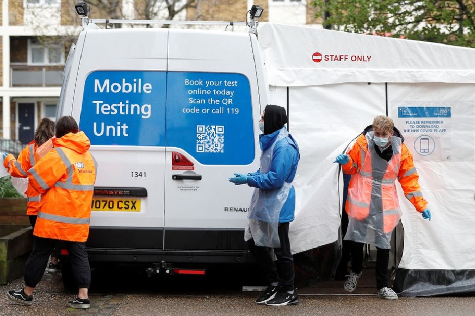 NHS workers are seen next to a coronavirus disease (COVID-19) mobile testing unit in Tower Hamlets, London, Britain, May 2, 2021. REUTERS/Peter Nicholls