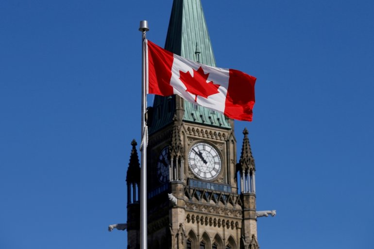 A Canadian flag flies in front of the Peace Tower on Parliament Hill in Ottawa, Ontario, Canada, March 22, 2017. REUTERS/Chris Wattie/File Photo
