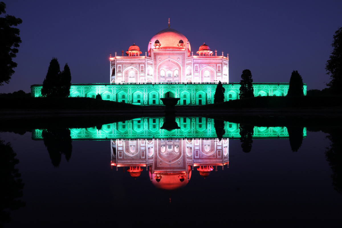 Humayun's Tomb is lit in tricolour as India celebrates the milestone of administering one billion COVID-19 vaccine doses, in New Delhi, India, October 21, 2021. REUTERS/Anushree Fadnavis
