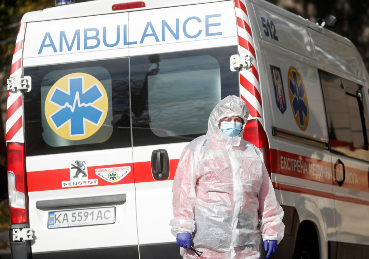 A medical specialist is seen next to an ambulance outside a hospital for patients infected with the coronavirus disease (COVID-19) in Kyiv, Ukraine October 21, 2021. REUTERS/Valentyn Ogirenko
