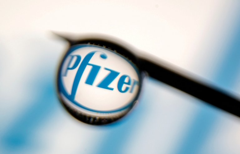 Pfizer logo is reflected in a drop on a syringe needle in this illustration photo taken March 16, 2021. REUTERS/Dado Ruvic/Illustration/File Photo/File Photo