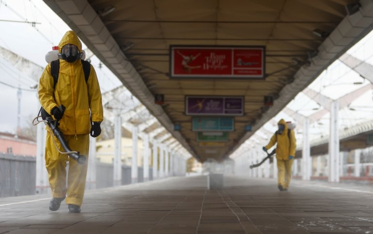 Specialists wearing personal protective equipment (PPE) spray disinfectant while sanitizing the Leningradsky railway station amid the outbreak of the coronavirus disease (COVID-19) in Moscow, Russia October 19, 2021. REUTERS/Maxim Shemetov