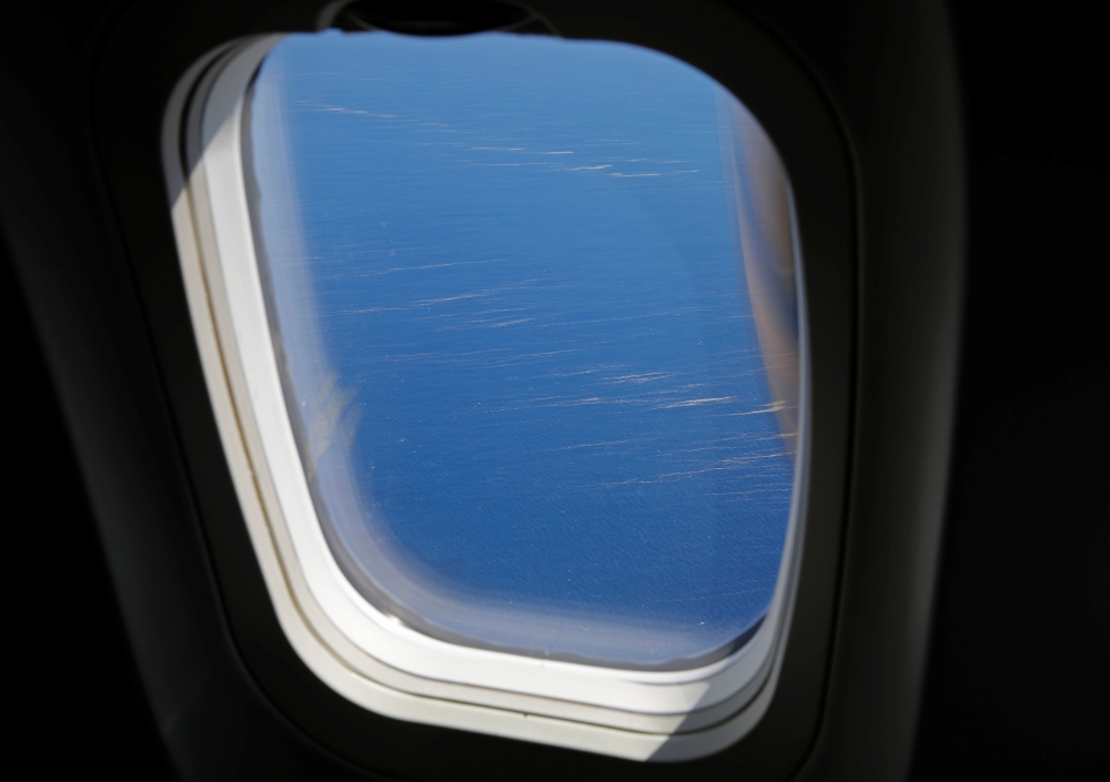 Drifting pumice stones, apparently from the eruption of an undersea volcano, are seen on the sea through the window of a commercial flight off the southern island of Okinawa, Okinawa prefecture, Japan, October 27, 2021. REUTERS/Issei Kato