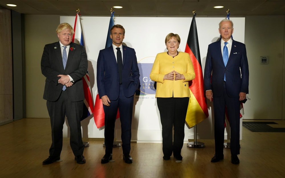 US President Joe Biden, Germany's Chancellor Angela Merkel, Britain's Prime Minister Boris Johnson and France's President Emmanuel Macron pose for a family photo during their meeting to discuss Iran's nuclear program, on the sidelines of the G20 leaders' 