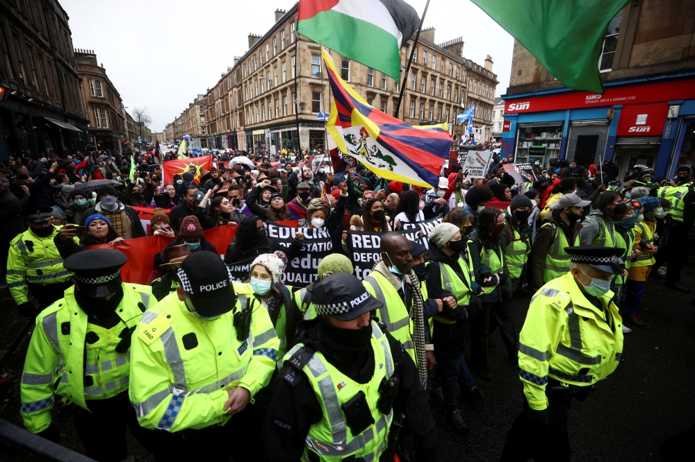 Police officers keep guard as demonstrators attend a protest amid the UN Climate Change Conference (COP26), in Glasgow, Scotland, Britain, November 6, 2021. Reuters/Hannah McKay