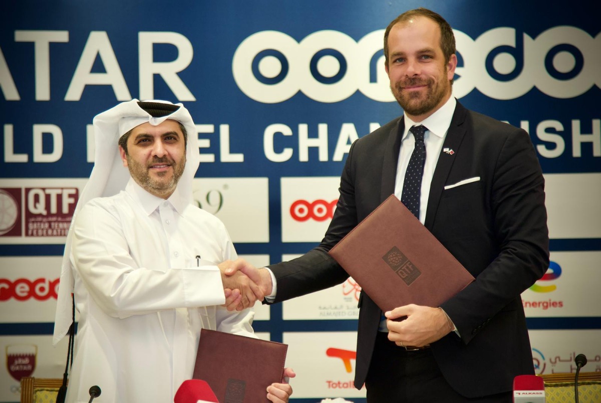 Qatar Tennis, Squash, Badminton Federation Secretary General Tariq Zainal and Managing Director of TotalEnergies Matthieu Bouyer shake hands after a sponsorship signing ceremony.