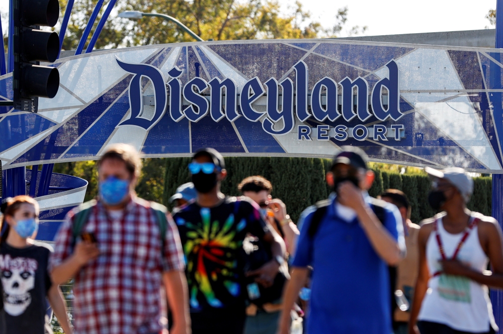 People leave the Disneyland Resort on Disneyland Park and Disney California Adventure's reopening day amidst the coronavirus disease (COVID-19) outbreak, in Anaheim, California, U.S., April 30, 2021. REUTERS/Mario Anzuoni/File Photo 