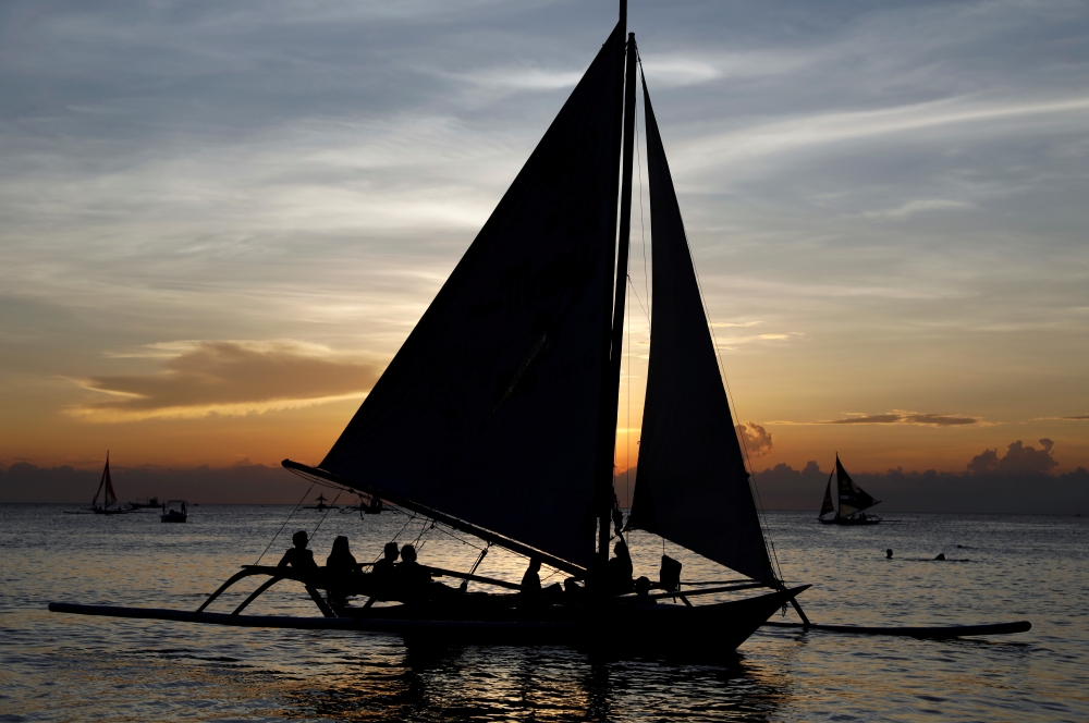 Tourists watch sunset aboard sailboats, one day before the temporary closure of the holiday island Boracay, in the Philippines April 25, 2018. REUTERS/Erik De Castro/File Photo