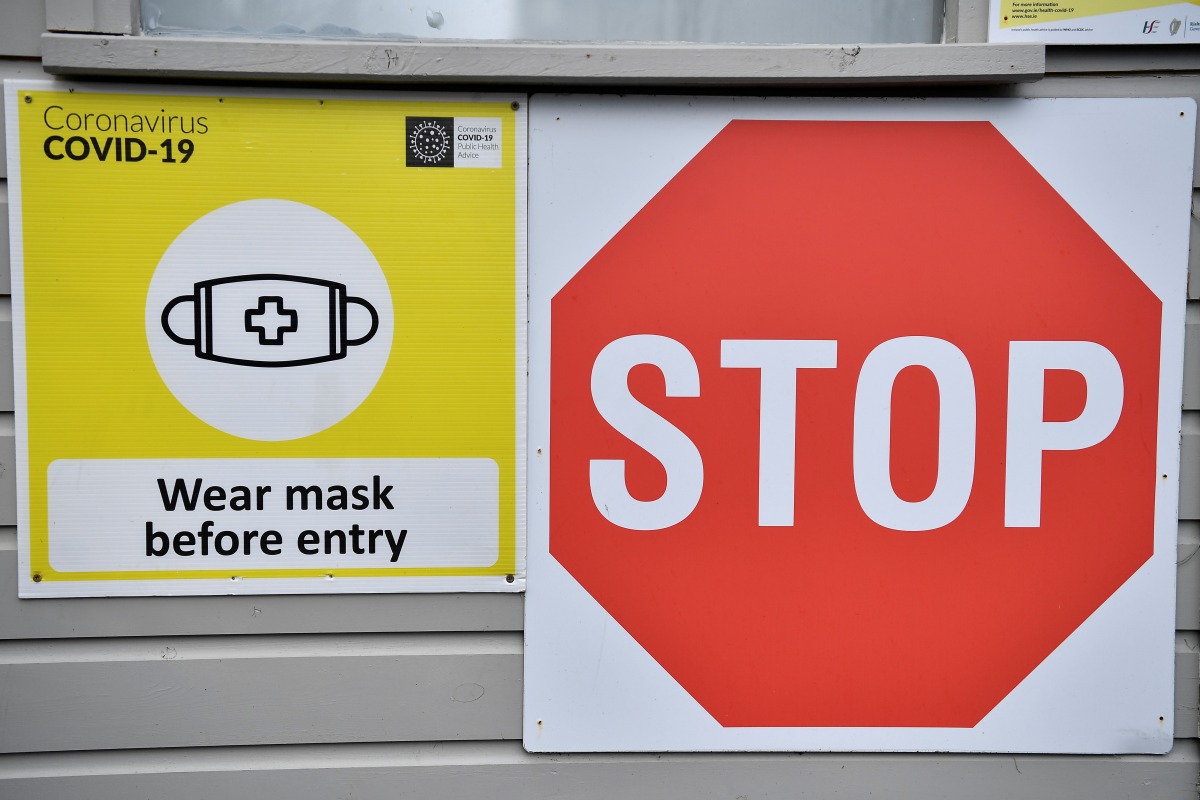 Signage to wear a face mask is seen outside a vaccination centre, as the spread of the coronavirus disease (COVID-19) continues in Dublin, Ireland, November 30, 2021. REUTERS/Clodagh Kilcoyne
