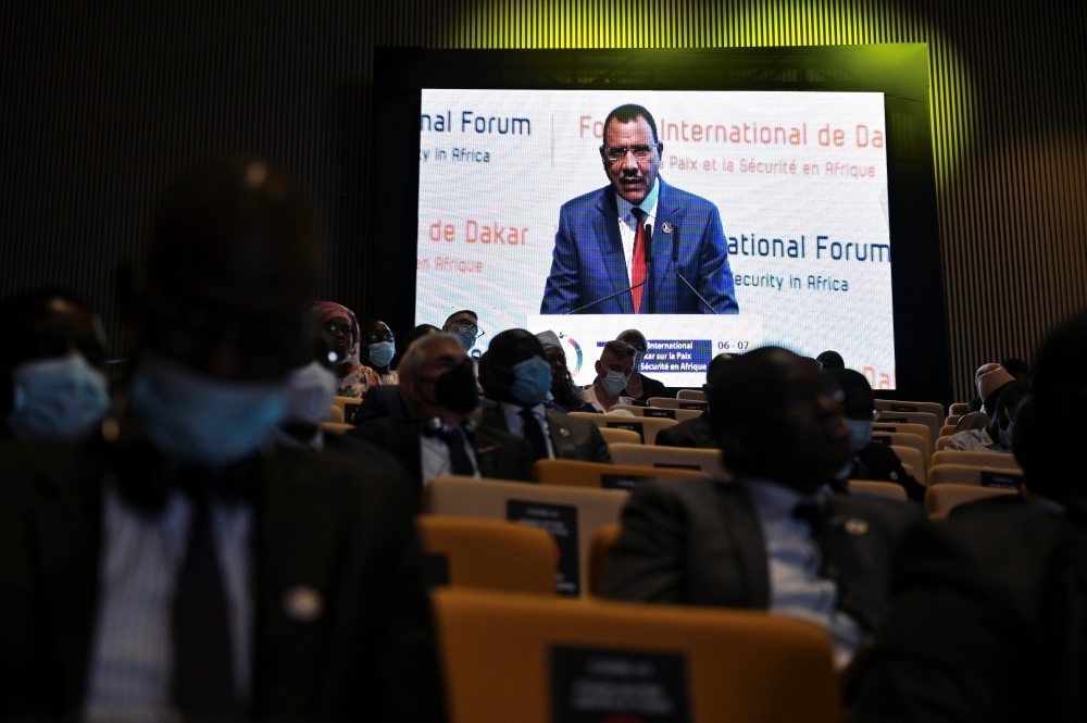 Niger President Mohamed Bazoum is seen on a screen as he speaks during the Dakar International Forum on Peace and Security (ISSAT) in Diamniadio, Senegal December 6, 2021. REUTERS