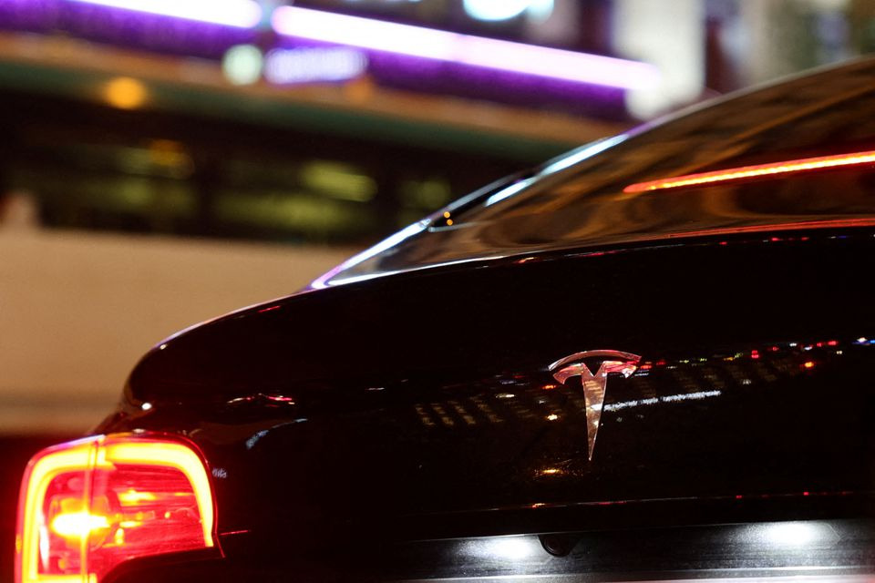 A Tesla logo is seen on a Parisian taxi car in Paris, France, December 14, 2021. REUTERS/Sarah Meyssonnier


