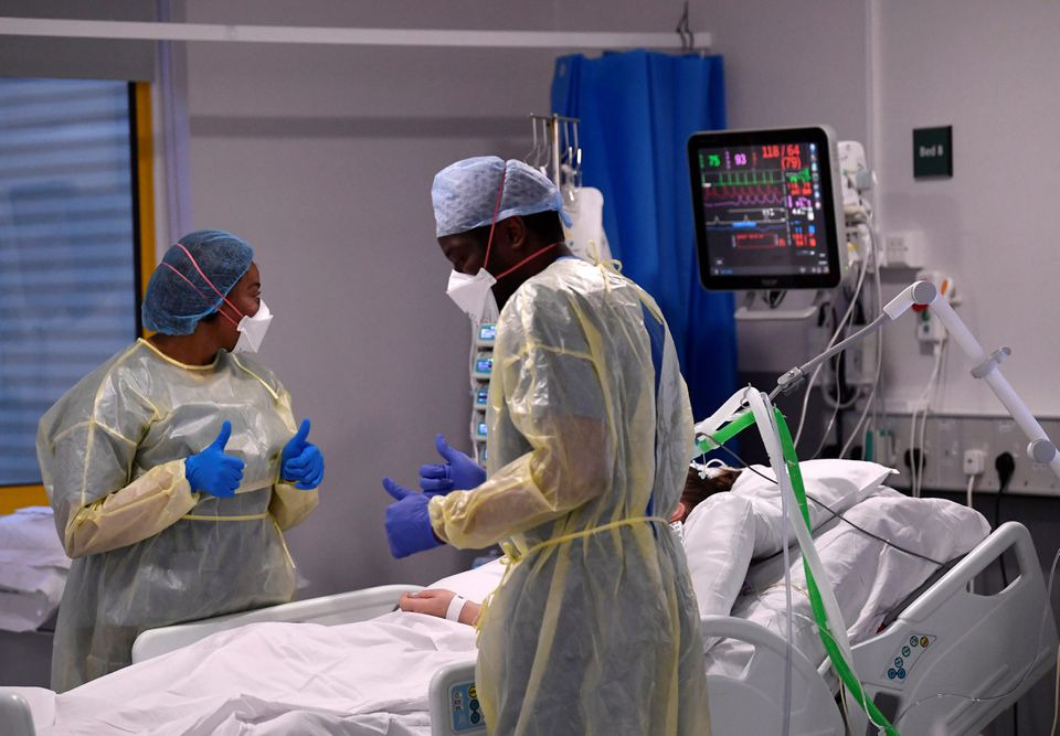 Nurses react as they treat a COVID-19 patient in the ICU (Intensive Care Unit) at Milton Keynes University Hospital, amid the spread of the coronavirus disease (COVID-19) pandemic, Milton Keynes, Britain, January 20, 2021. REUTERS/Toby Melville
