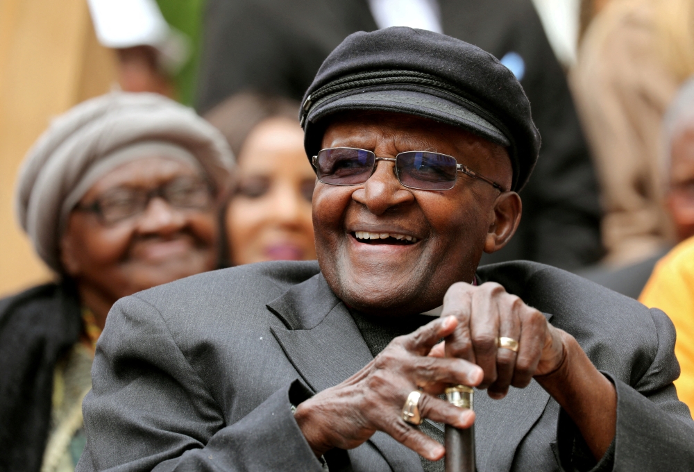 Archbishop Desmond Tutu laughs as crowds gather to celebrate his birthday by unveiling an arch in his honour outside St George's Cathedral in Cape Town, South Africa, October 7, 2017. Reuters/Mike Hutchings/File Photo