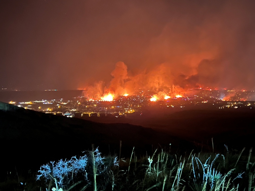 Buildings burn as a wind-driven grass fire destroys hundreds of homes, displaces thousands, as seen from Denver, Colorado, U.S. December 30, 2021. Gregg Corella/Handout via REUTERS