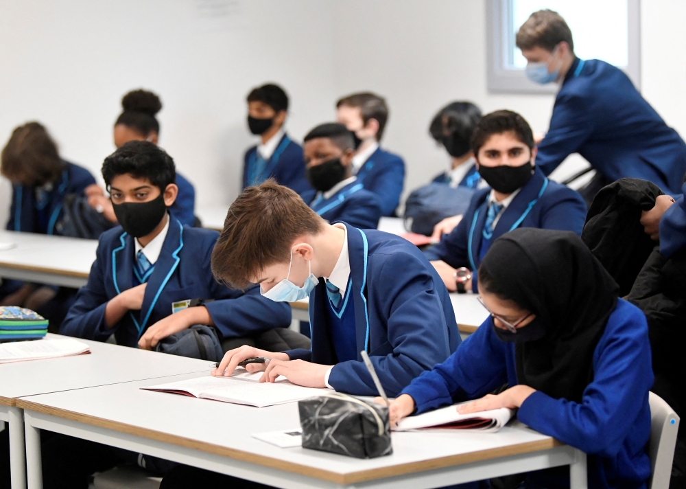 Year 9 students wear protective face masks as they take part in lessons on the first day back at school, as the coronavirus disease (COVID-19) lockdown begins to ease at Harris Academy Sutton, south London, Britain, March 8, 2021. REUTERS/Toby Melville/File Photo