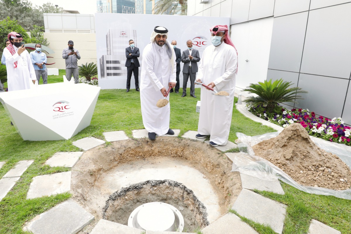 Salem Al Mannai (second right front), Group CEO of QIC Group, buries the ‘Time Capsule’, while other officials look on, at a function, in Doha, recently.