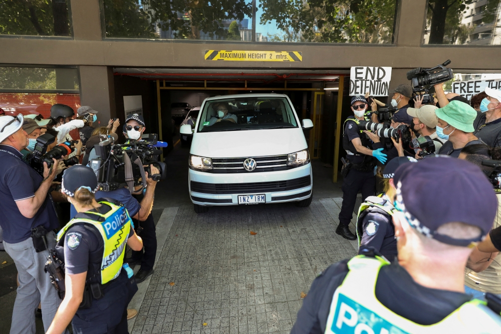 Members of the media waiting for a sighting of Serbian tennis player Novak Djokovic surround a departing transport vehicle exiting the Park Hotel, in Melbourne, Australia, January 10, 2022. Reuters/Asanka Brendon Ratnayake
