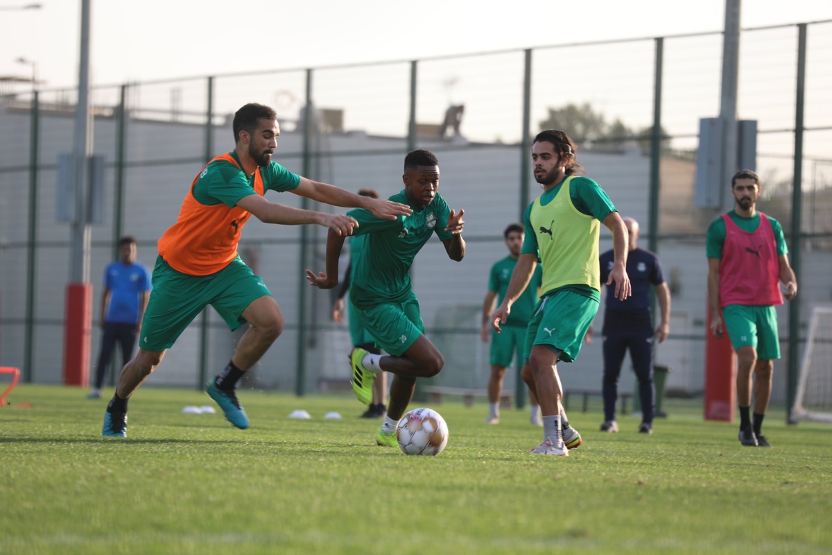 Al Ahli players in action during a training session.