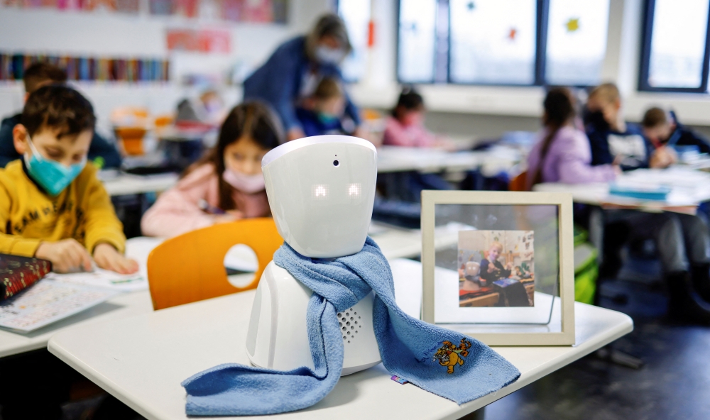 A seven-year-old schoolboy Joshua attends his school lesson via a robot avatar, placed in his classroom, in Berlin, Germany January 13, 2022. Picture taken January 13, 2022. REUTERS/Hannibal Hanschke