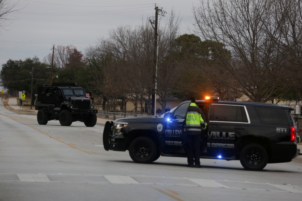Law enforcement vehicles are seen in the area where a man has reportedly taken people hostage at a synagogue during services that were being streamed live, in Colleyville, Texas, U.S. January 15, 2022. Reuters/Shelby Tauber
