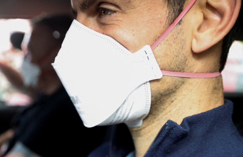 Serbian tennis player Novak Djokovic departs the Park Hotel while under immigration detention, to convene with his legal team after his visa to play in the Australian Open was cancelled a second time, in Melbourne, Australia, January 16, 2022. Reuters/Loren Elliott