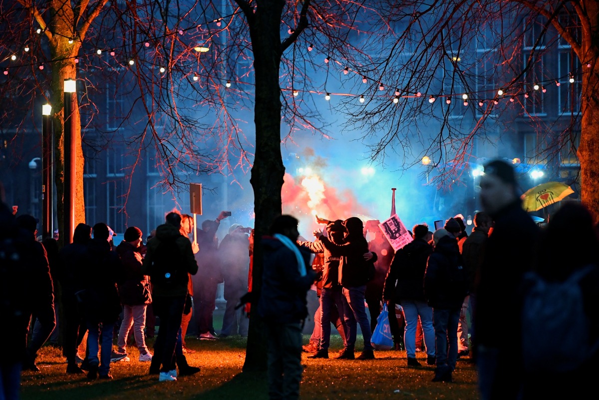 Demonstrators take part in a protest against the Dutch government's restrictions imposed to contain the spread of the coronavirus disease (COVID-19), in Amsterdam, Netherlands, January 16, 2022. REUTERS/Piroschka van de Wouw
