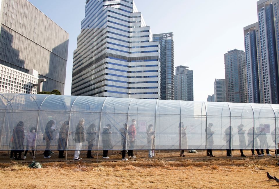 People wait in a line to undergo coronavirus disease (COVID-19) testing at a temporary testing site set up at a railway station in Seoul, South Korea, December 8, 2021. REUTERS/Heo Ran

