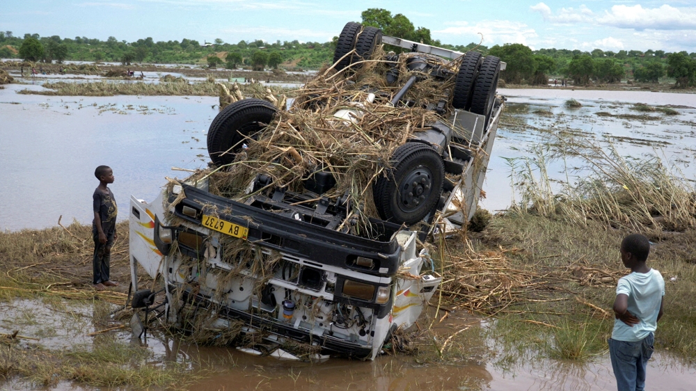 Locals look at a wreck washed away during Tropical Storm Ana on the flooded Shire river, an outlet of Lake Malawi at the village of Thabwa in Chikwawa district, southern Malawi, January 26, 2022. REUTERS/Eldson Chagara/File Photo