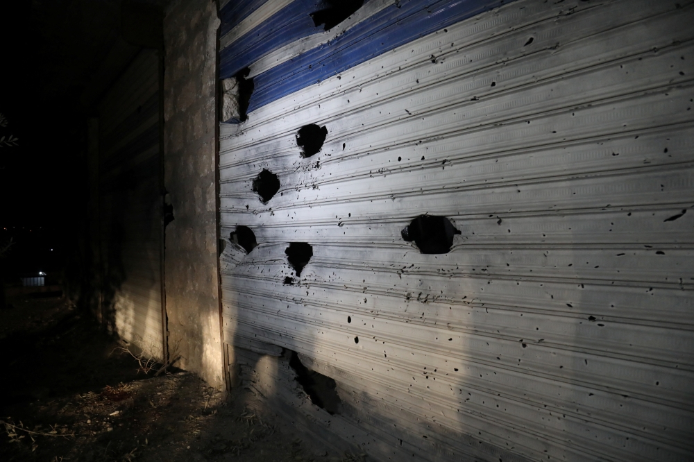 A damaged shutter is seen on a building in the aftermath of a counter-terrorism mission conducted by the U.S. Special Operations Forces in Atmeh, Syria, February 3, 2022 in this picture obtained from social media. Courtesy of Mohamed Al-Daher/via Reuters 