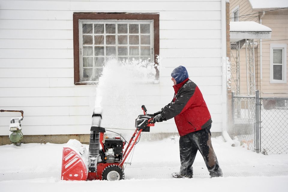 Ken Sayen helps clear the roads and sidewalks in his neighborhood during a snowstorm in Toledo, Ohio, U.S., February 3, 2022. REUTERS/Gaelen Morse


