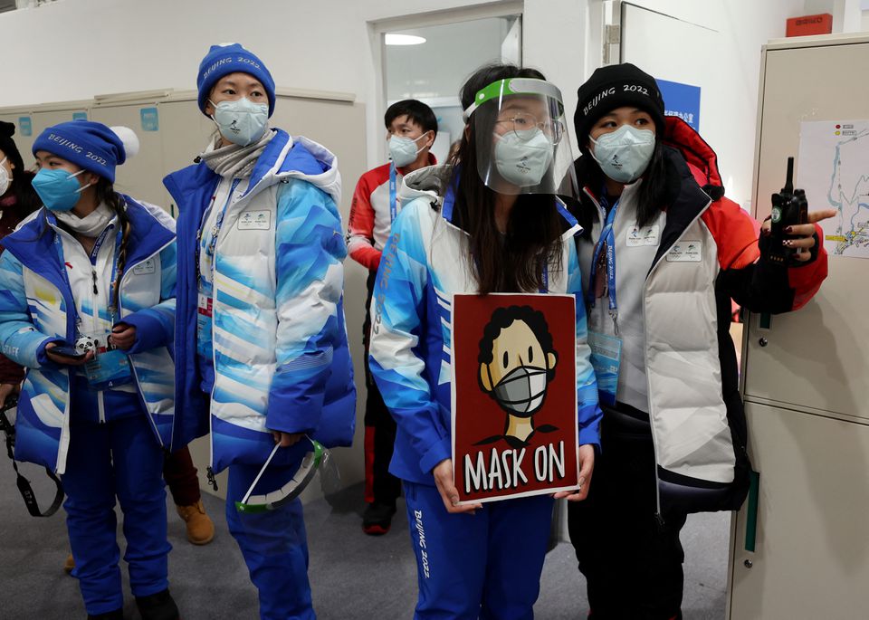 A staff member holds a sign 