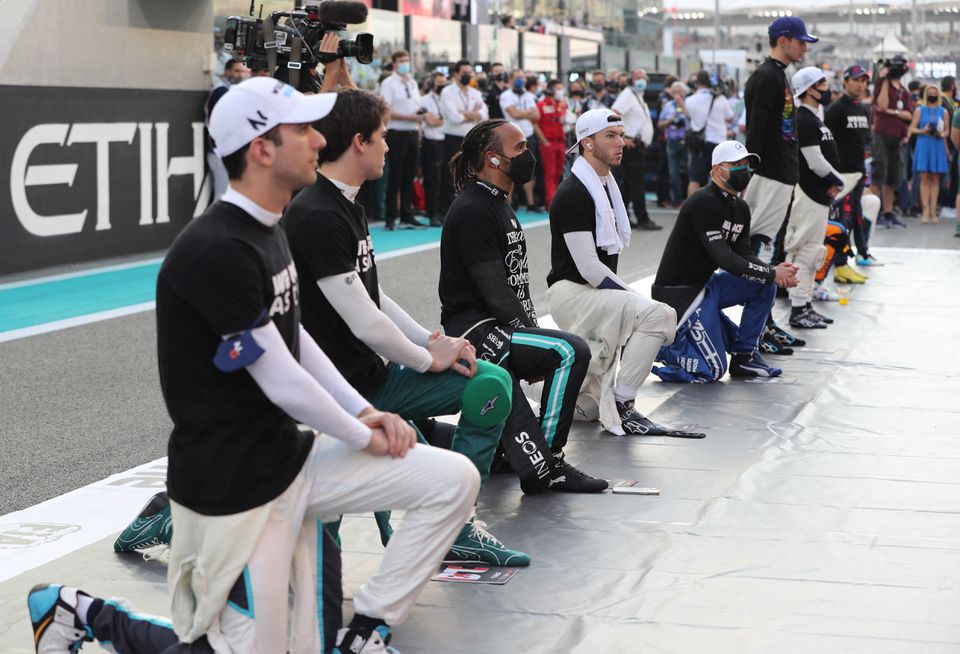 FILE PHOTO: Mercedes' Lewis Hamilton and other drivers take a knee before the race Pool via REUTERS/Kamran Jebreili


