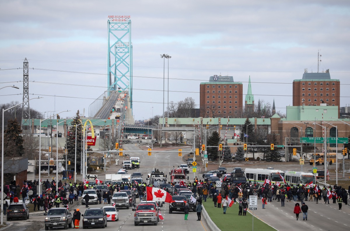 Truckers and supporters block access to the Ambassador Bridge, which connects Detroit and Windsor, in protest against coronavirus disease (COVID-19) vaccine mandates, in Windsor, Ontario, Canada February 12, 2022. REUTERS/Carlos Osorio
