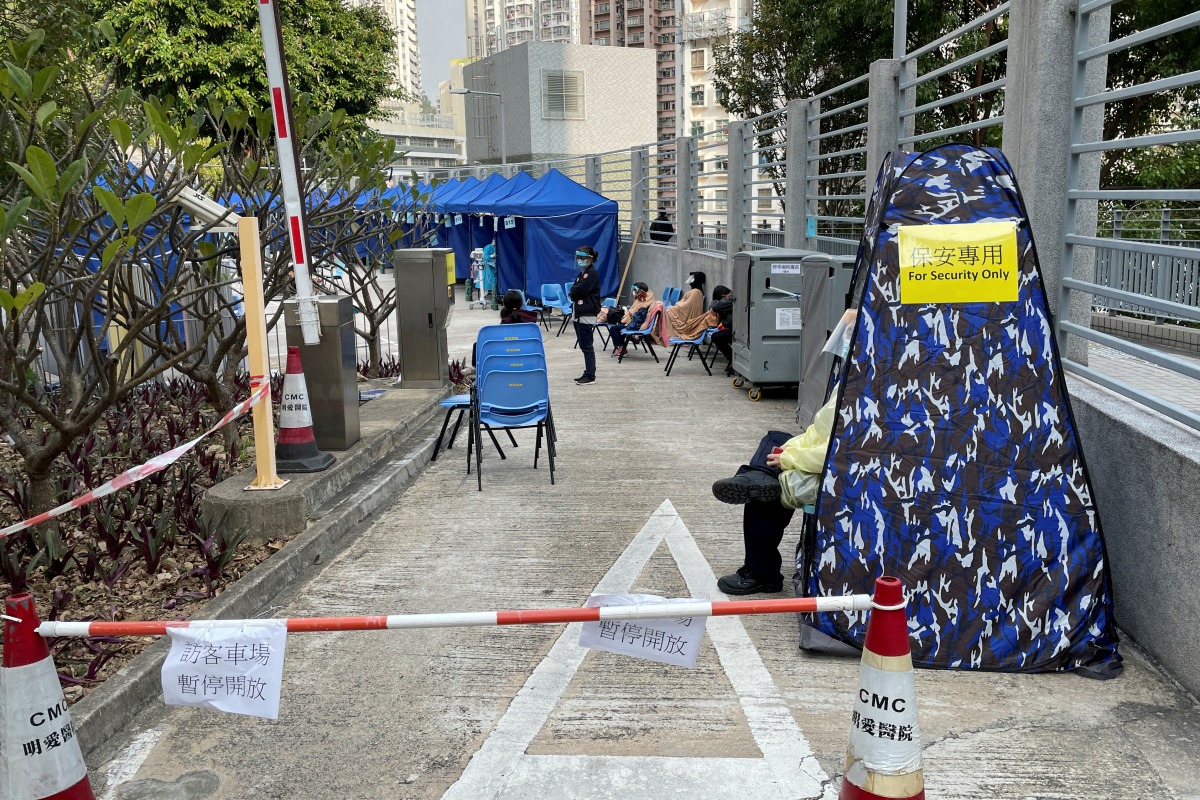 FILE PHOTO: A security guard wearing a face mask and face shield sits at an area outside a hospital, following the coronavirus disease (COVID-19) outbreak in Hong Kong, China February 16, 2022. REUTERS/Aleksander Solum/File Photo
