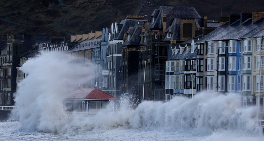 Waves caused by Storm Eunice break over Aberystwyth promenade in Aberystwyth, Wales, Britain, February 18, 2022. REUTERS/Carl Recine