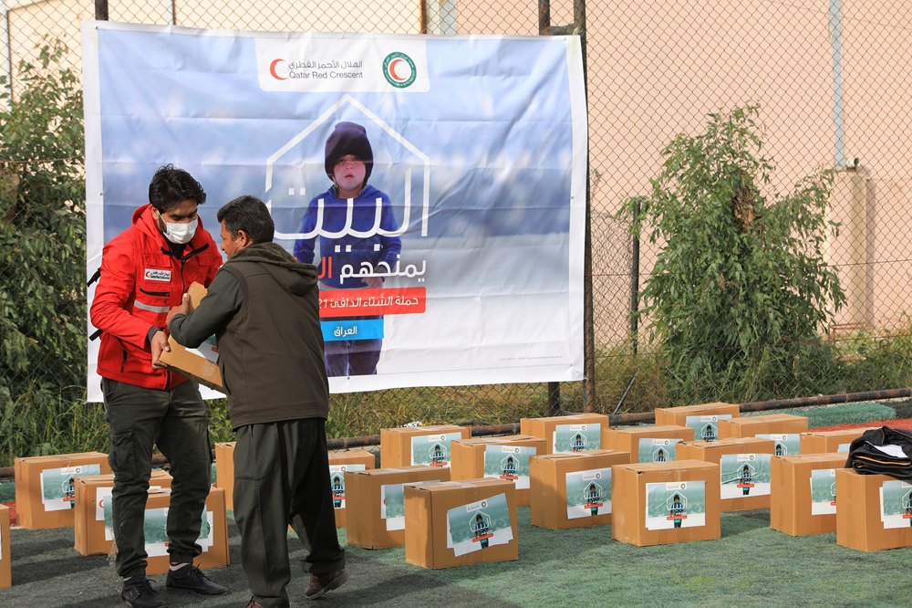 A beneficiary receiving aid provided by QRCS under its winterisation project in Iraqi Kurdistan.