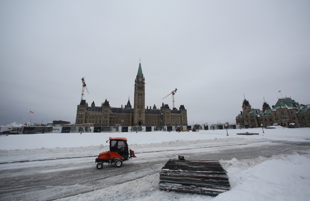 A winter service vehicle drives, as Canadian police officers work to evict the last of the trucks and supporters occupying the downtown core, three weeks after a protest against coronavirus disease (COVID-19) vaccine mandates began, at Parliament Hill in Ottawa, Ontario, Canada, February 20, 2022. REUTERS/Lars Hagberg
