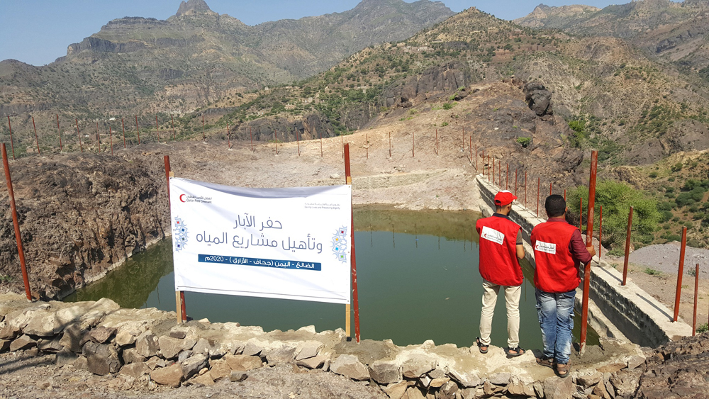 QRCS volunteers and local residents at two of the water projects implemented by QRCS in Yemen.