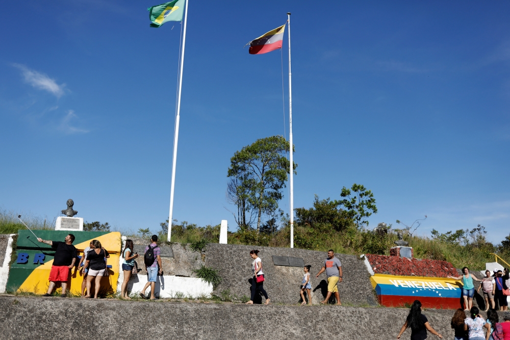 People stand at the border with Venezuela, seen from the Brazilian city of Pacaraima, Roraima state, Brazil November 16, 2017. REUTERS/Nacho Doce/File Photo