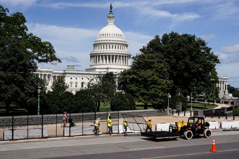 FILE PHOTO: Workers remove security fencing as a reduction in heightened security measures taken after the January 6th attack on the U.S. Capitol in Washington, U.S., July 10, 2021. REUTERS/Joshua Roberts


