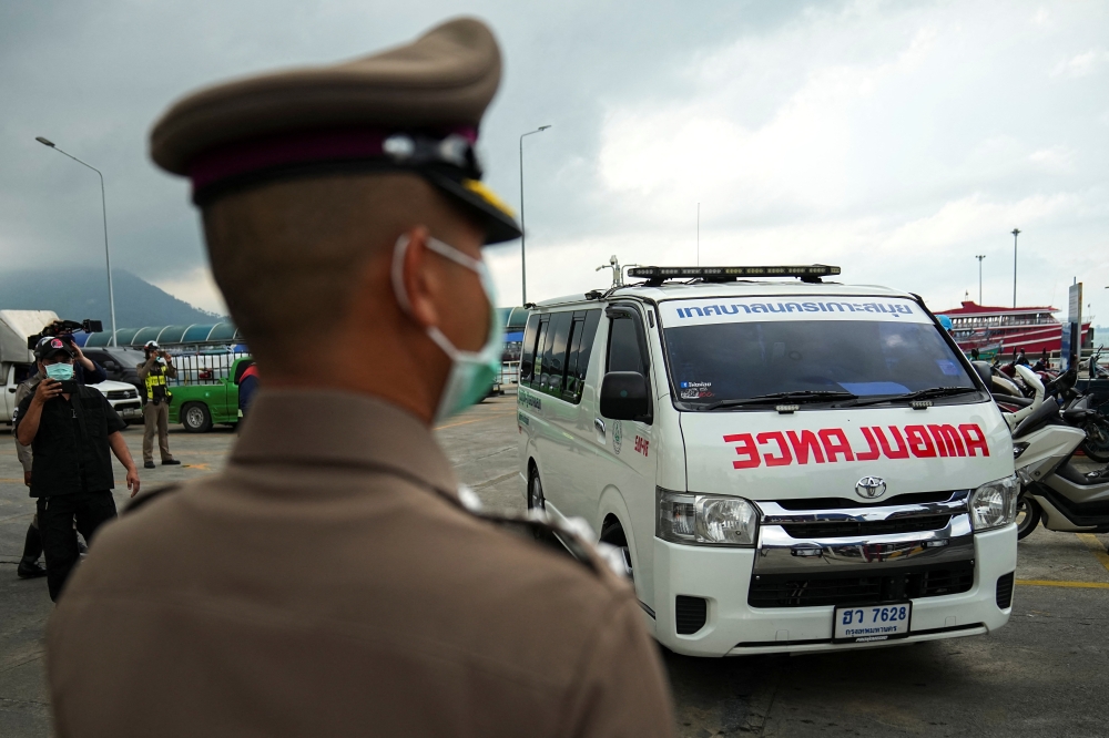 An ambulance carrying the body of Australian cricket player Shane Warne leaves at a ferry port in Koh Samui, Thailand, March 6, 2022. Reuters/Athit Perawongmetha