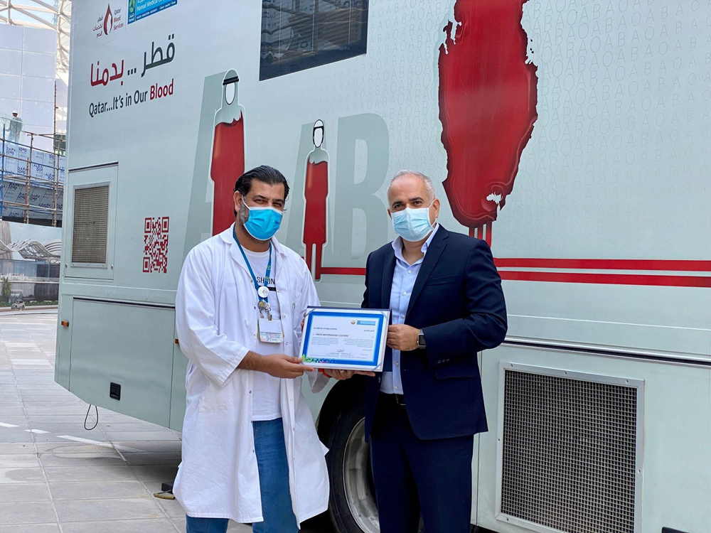 A certification of appreciation is being given to the organisers during the campaign.