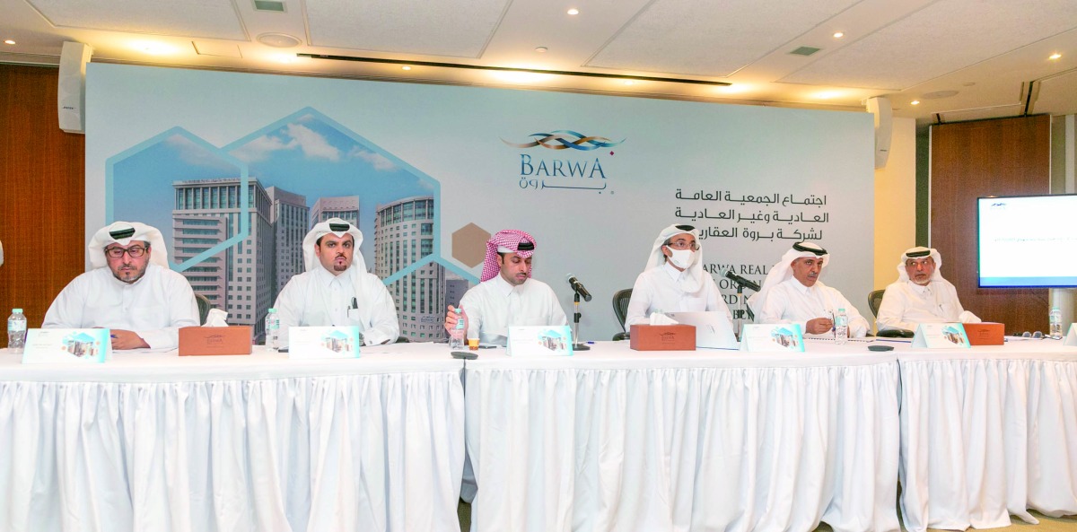 H E Salah bin Ghanem Al Ali (third right), Chairman of the Board of Directors and other officials during the Ordinary General Assembly Meeting of Barwa Real Estate Company held yesterday.