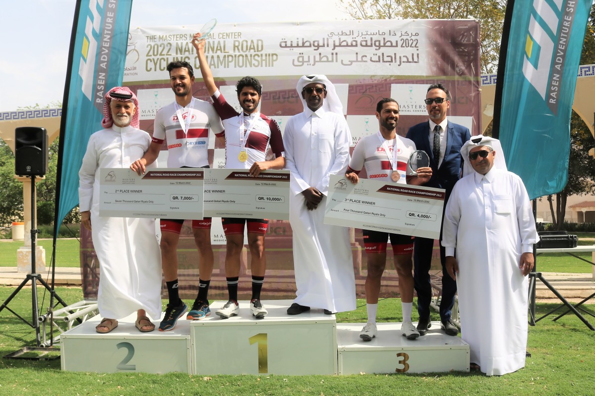 The officials and podium winners pose for a photograph.
