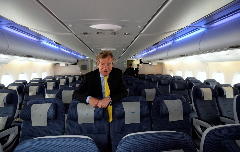 FILE PHOTO: British Airways Chairman Martin Broughton poses for photographs in the world traveller cabin of the British Airways Airbus A380 at Heathrow airport in London July 4, 2013. REUTERS/Paul Hackett