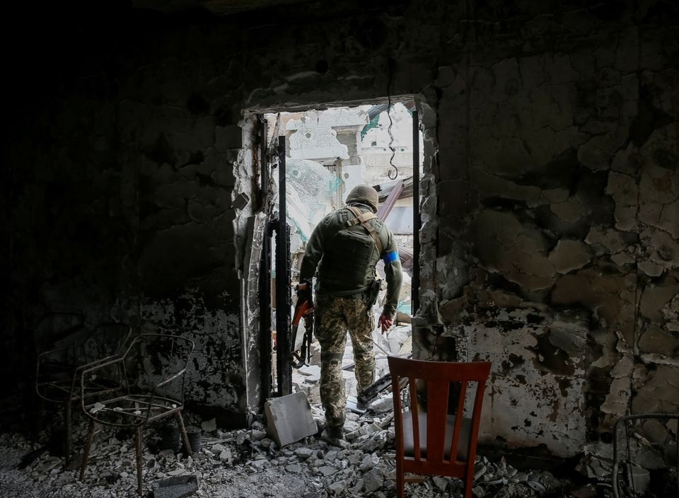 A Ukrainian service member walks on the front line near Kyiv as Russia's invasion of Ukraine continues, Ukraine March 29, 2022. REUTERS/Gleb Garanich